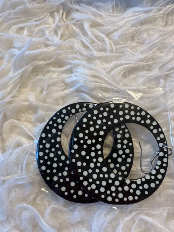 Black earrings with white polka dots