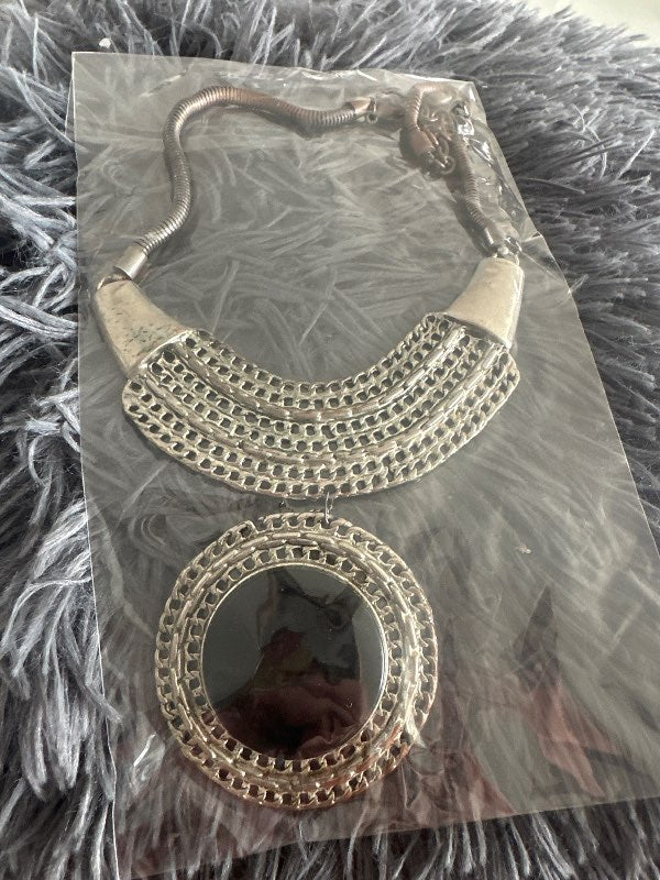 Silver necklace with black circle