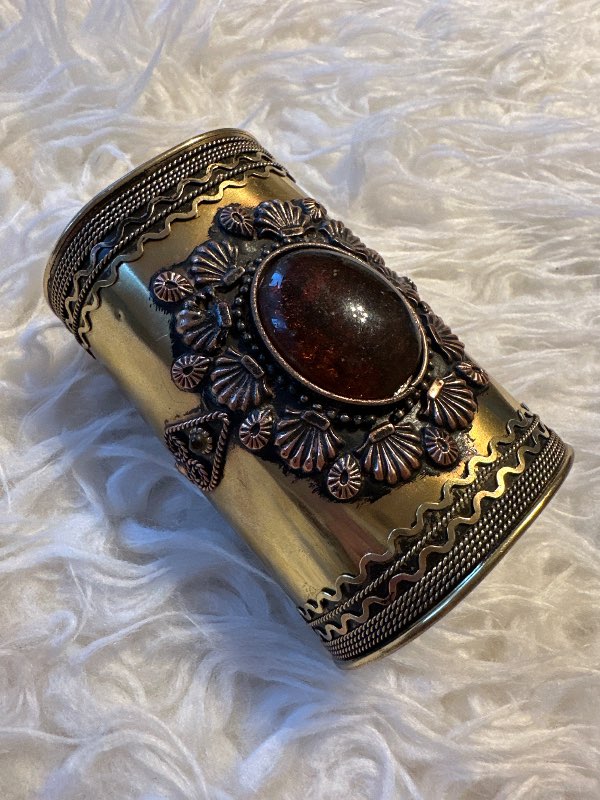 Golden bracelet with stone and pattern