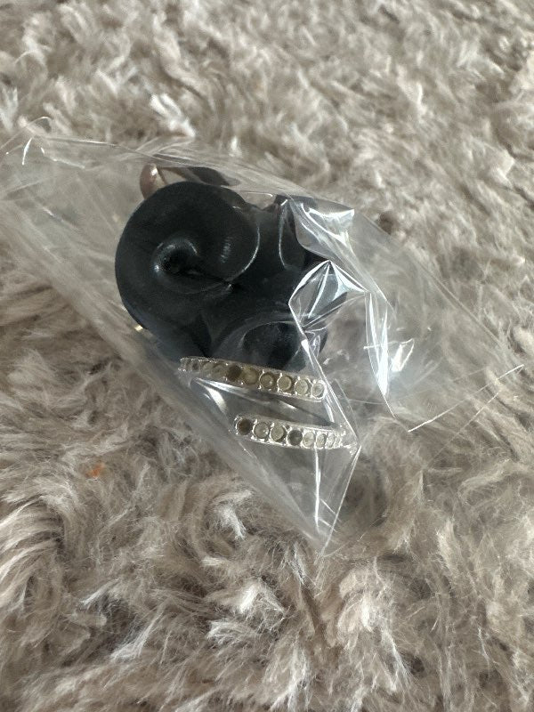 2 rings, a black rose and another with a missing white stone