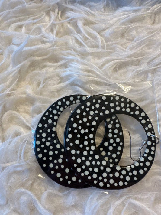 Black earrings with white polka dots
